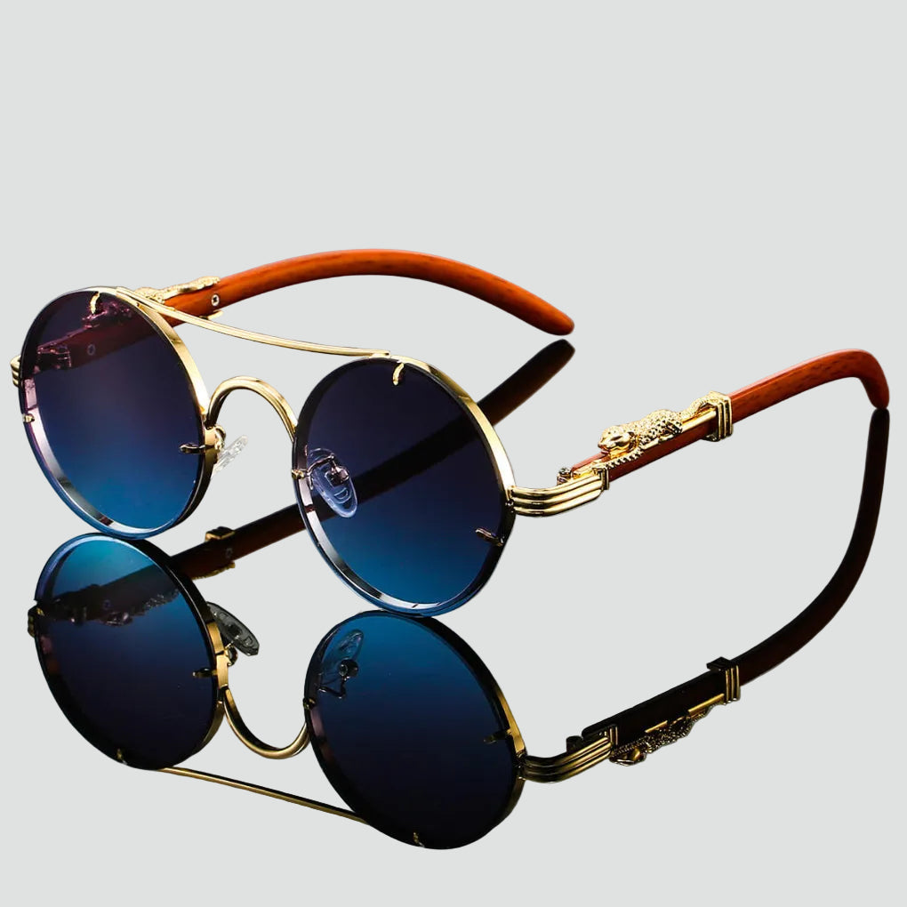 Okulary przeciwsłoneczne damskie w stylu retro z okrągłymi niebieskimi szkłami i złotą metalową oprawką z dekoracyjnymi zausznikami