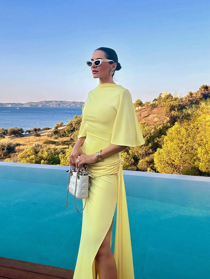 Damska Sukienka Maxi Na Wesele w żółtym kolorze z szerokim rękawem i rozcięciem z boku