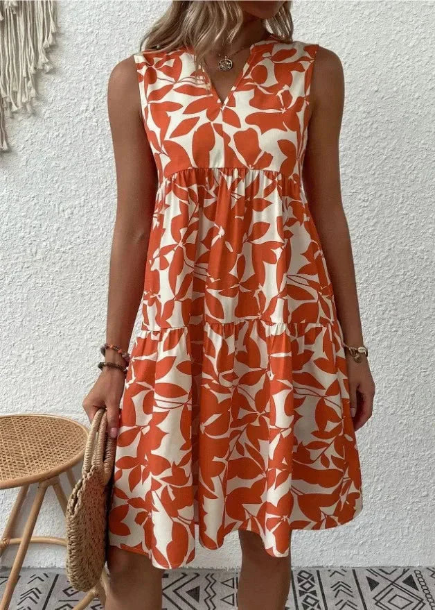 Elegancka sukienka letnia midi w pomarańczowo-kremowy wzór geometryczny z dekoltem w serek i falbaniastymi warstwami